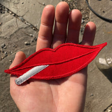 Vintage smoking lips patch with red lips smoking a cigarette. New old stock embroidered patch for sale.